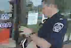 Still video shot of a police officer outside the office of Conservative Justice Minister Rob Nicholson's MP office in Niagara Falls.